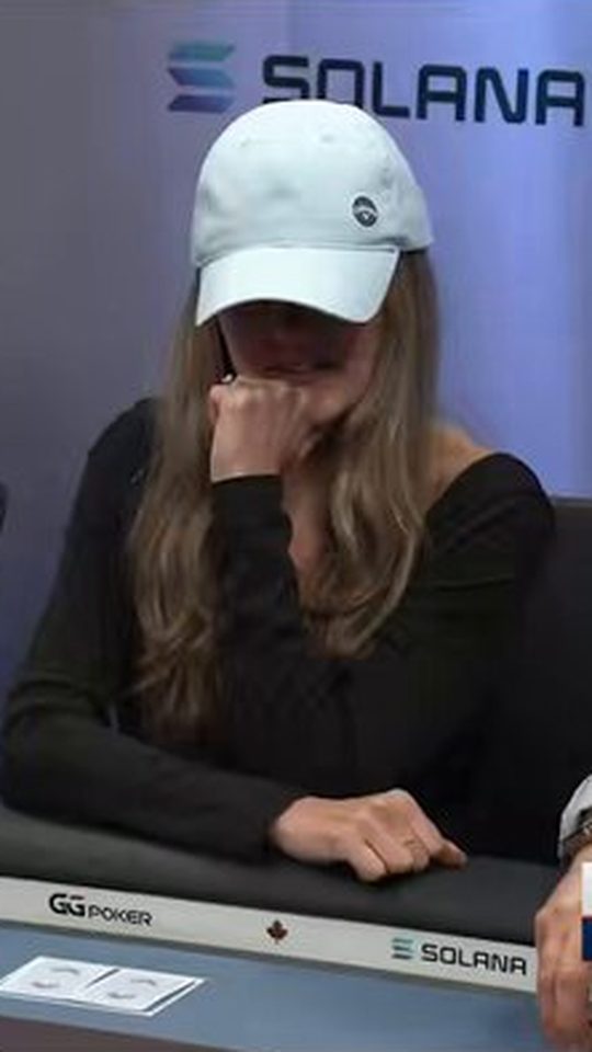 Lexy in a white cap with her hand to her chin at the WSOP Main Event feature table