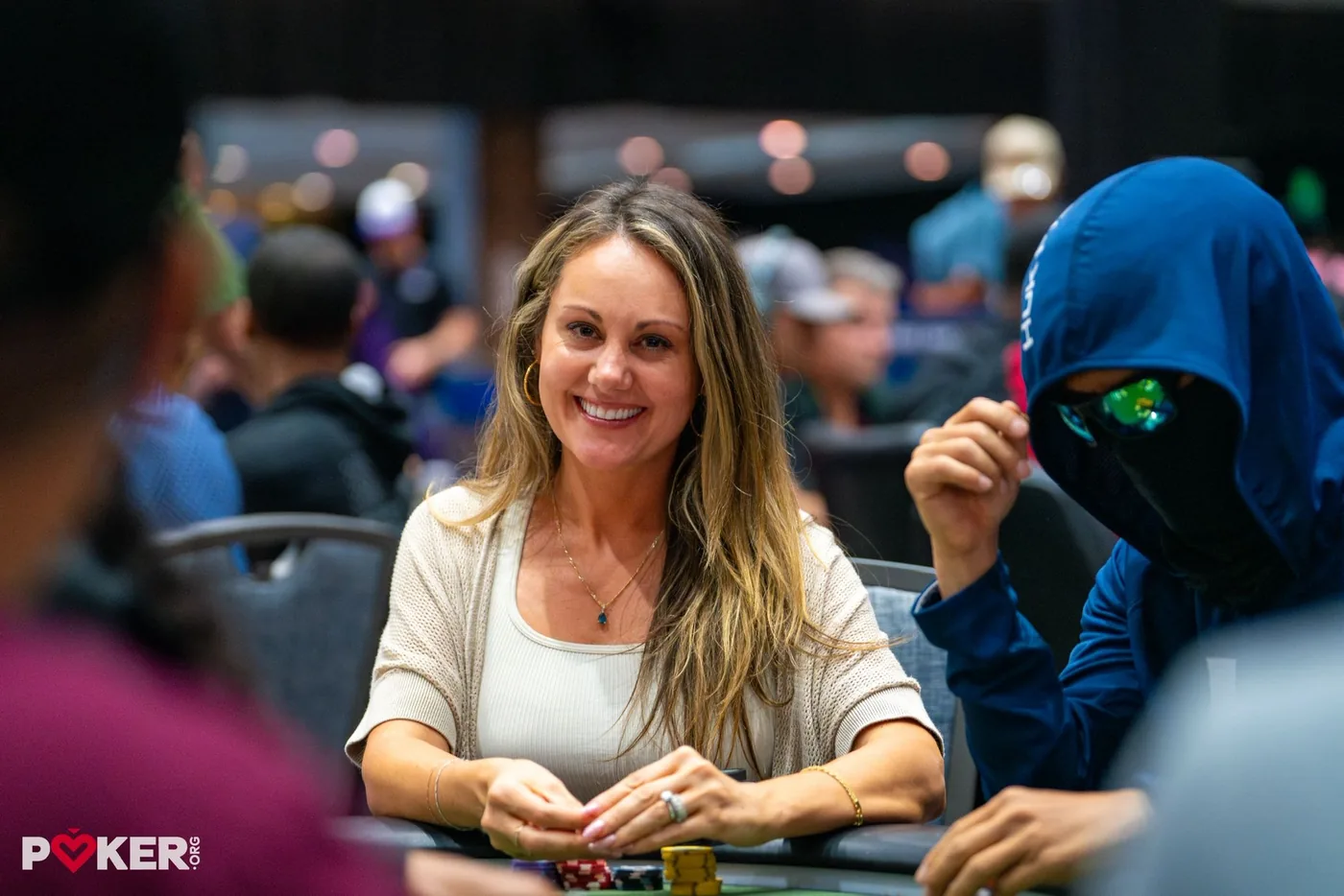 Lexy Gavin-Mather smiling at a tournament poker table